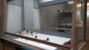 A fume hood stands ready to suck noxious fumes from adhesives.